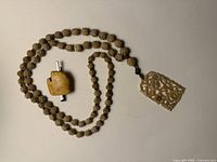 Amber tie clip and bone necklace overview