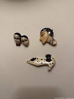 All three brooches grouped together on neutral background