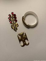 Overview of three jewellery pieces on white surface