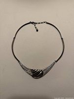 Full view of sterling collar necklace laid flat showing centerpiece and extension chain