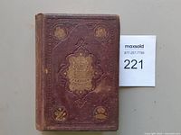 Front cover of purple cloth book showing gilt title block and wear