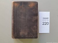 Front cover of worn brown cloth hardcover