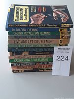 Stack of all 13 paperbacks showing spines