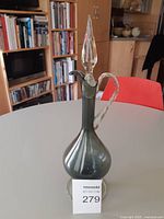 Full view of smoky grey glass decanter with stopper