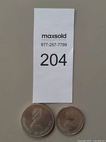 Two coins with lot tag visible
