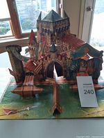 Front view of open pop-up castle scene inside book