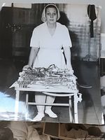 Nurse behind table of surgical instruments photograph