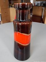 Front view showing brown glaze and red-orange band