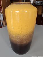 Front view of tall yellow-to-brown glazed vase