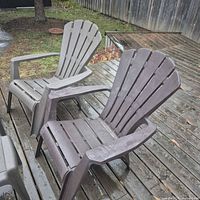 Two resin Muskoka chairs and stools on deck