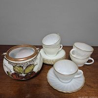 Group view of biscuit barrel, stacked saucers, and multiple teacups