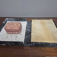 Soapstone box and sketchbook with case side by side