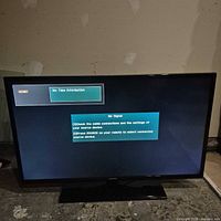 Front view of Samsung 39" TV powered on displaying 'No Signal' dialog