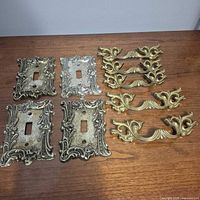 Group shot of all switch covers and drawer pulls on surface