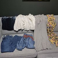 All six clothing items laid out on sofa