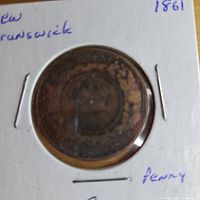 Coin in holder, reverse side visible through plastic window