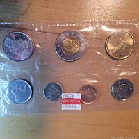 Front of sealed 2011 Canadian uncirculated coin set showing seven coins