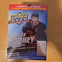 Front view of sealed 2021-22 Upper Deck Series One Hockey blaster box showing bonus pack notice
