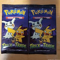 Front view of two sealed Pokémon Trick or Trade booster packs