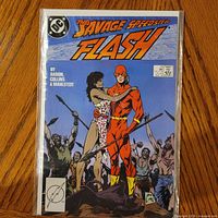Front cover of The Flash #10 comic in protective polybag and board