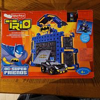 Front of boxed Fisher-Price Trio Batcave set showing Batman graphic, Batmobile and piece count