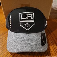 Front view of hat showing LA Kings crest, side text, Adidas logo, grey visor