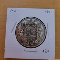 Reverse of 1941 Canada 50-cent coin showing coat of arms and date