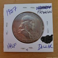 Obverse of 1957 Franklin half dollar in cardboard 2x2 holder
