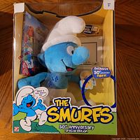 Front of boxed Smurfs 50th Anniversary Special Edition showing plush, DVD and sketch