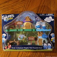 Front view of sealed Smurfs Micro Village Handy & Clockwork 7-piece set