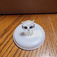 Front view of clear Swarovski crystal owl figurine on temporary stand