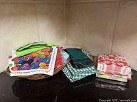 Napkins stacked beside wicker bowl on countertop