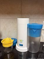 Iced tea maker, pitcher, citrus juicer pieces grouped