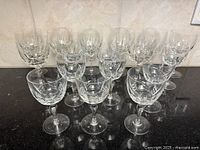 Frontal view of all fourteen Nachtmann cut crystal wine glasses arranged by size