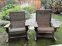 Front view of both wooden slat rocking chairs on lawn