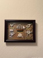 Full view of framed nautical shadow box on wall