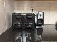 Front view of Hamilton Beach 4-slice toaster and Smooth Touch electric can opener on countertop