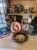 Entire lot with wreath, plates, boxed and unboxed snow globes, figurines and tabletop tree