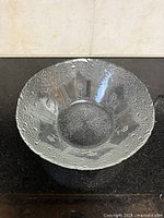 Overhead view of entire clear etched glass bowl with textured rim
