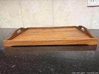 side view of teak serving tray showing profile and grain