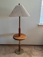 Full view of brass and wood floor lamp with tray table and shade