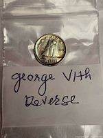 Obverse/reverse visible Canadian 1943 10-cent coin in plastic sleeve