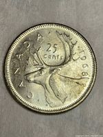 Reverse side of 1968 Canadian quarter showing caribou and date