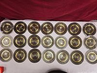 All 21 brass plates laid out face up