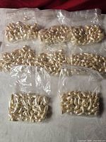 Multiple bags containing white teardrop faux pearl beads