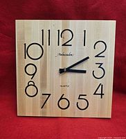 Front view of wooden square wall clock