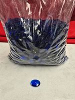 Full bag of sapphire blue plastic faceted pieces