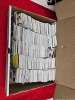 Full view of cardboard box filled with vertically stacked trading cards