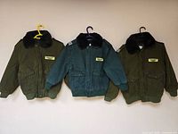 All three jackets hanging side by side