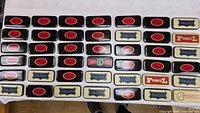 Top-down view showing full assortment of tins laid out in rows